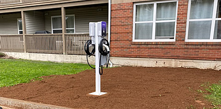 An image of an Electric Vehicle (EV) charging station installed by Henderson Electrical at a multi-residential housing unit in Halifax, Nova Scotia